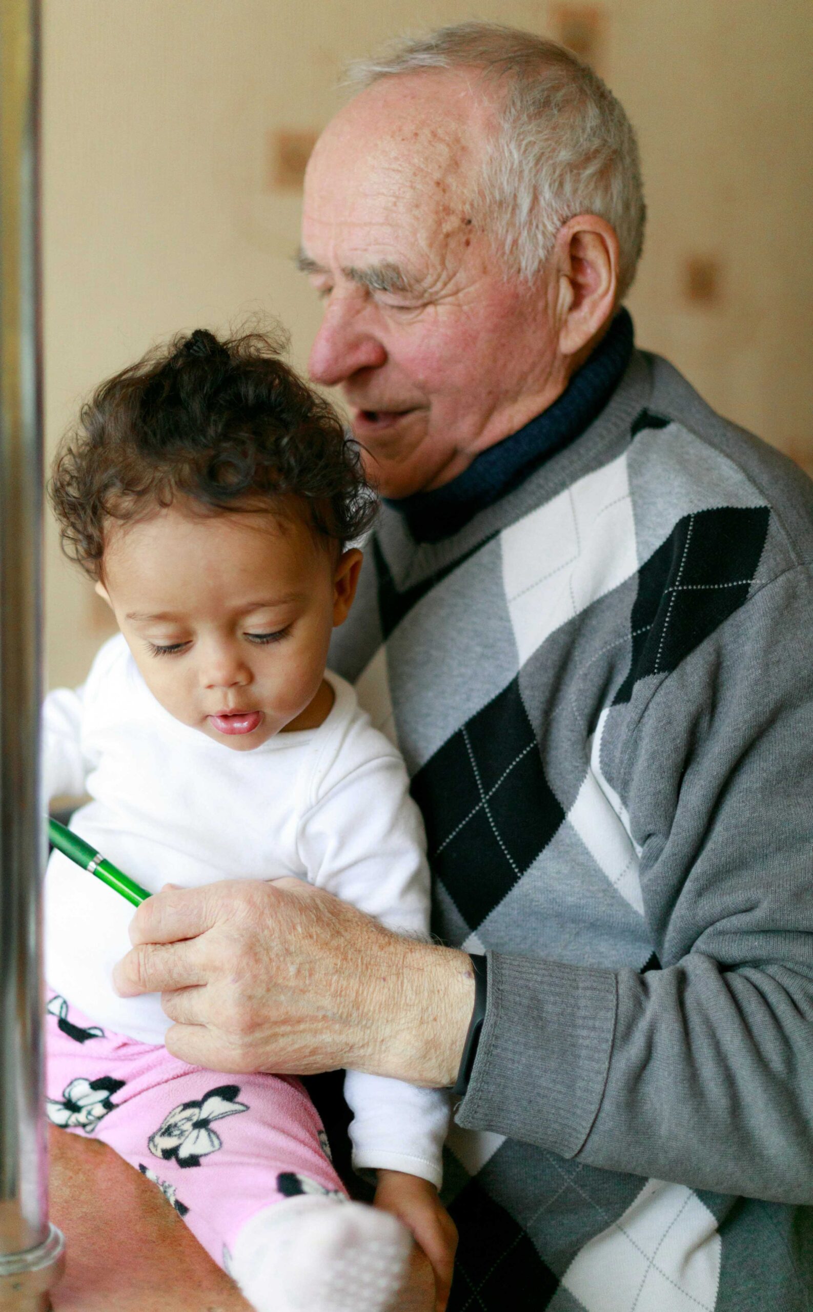 therapy for grief and loss. Grandfather holding a toddler.