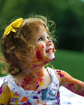 Margot Holloman  young girl with fingerpaint all over.