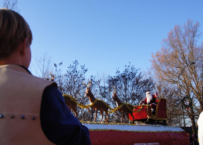 balance self-care holiday. little boy watching xmas parade